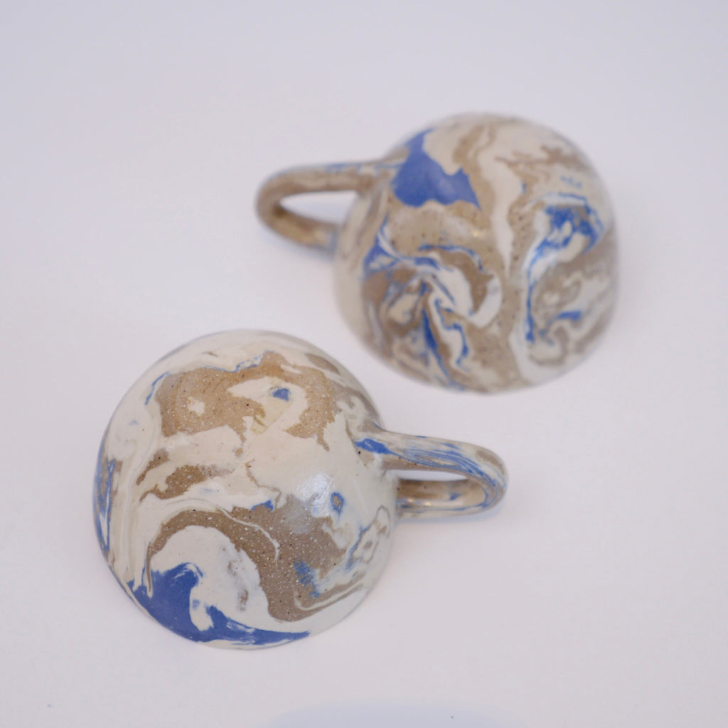 Marbled patterned cufflinks on a white background