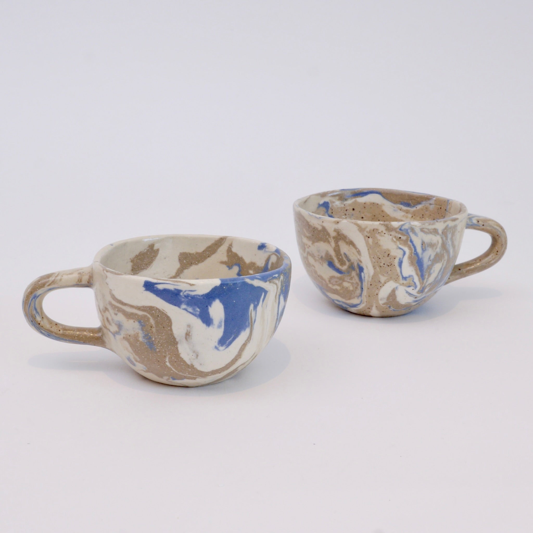 Set of two handmade marbled ceramic espresso cups with matte clear glaze